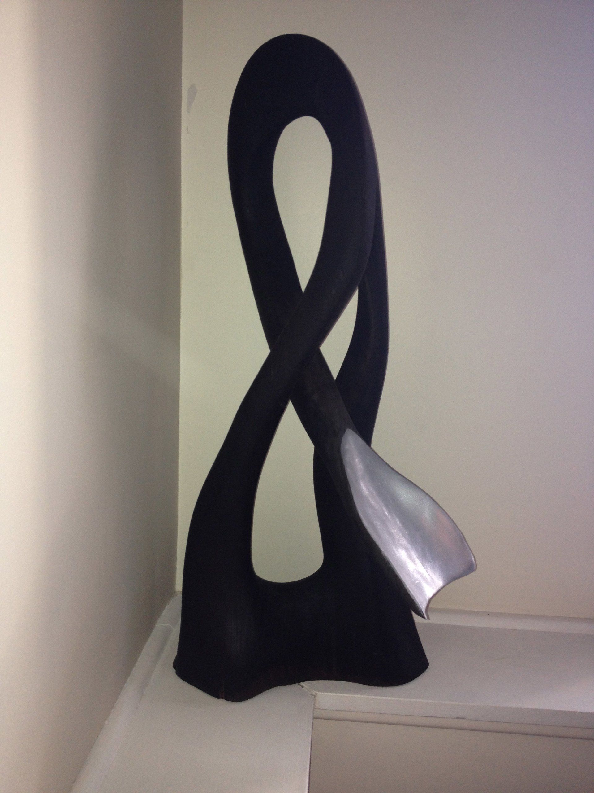 A black sculpture with an infinity symbol on it
