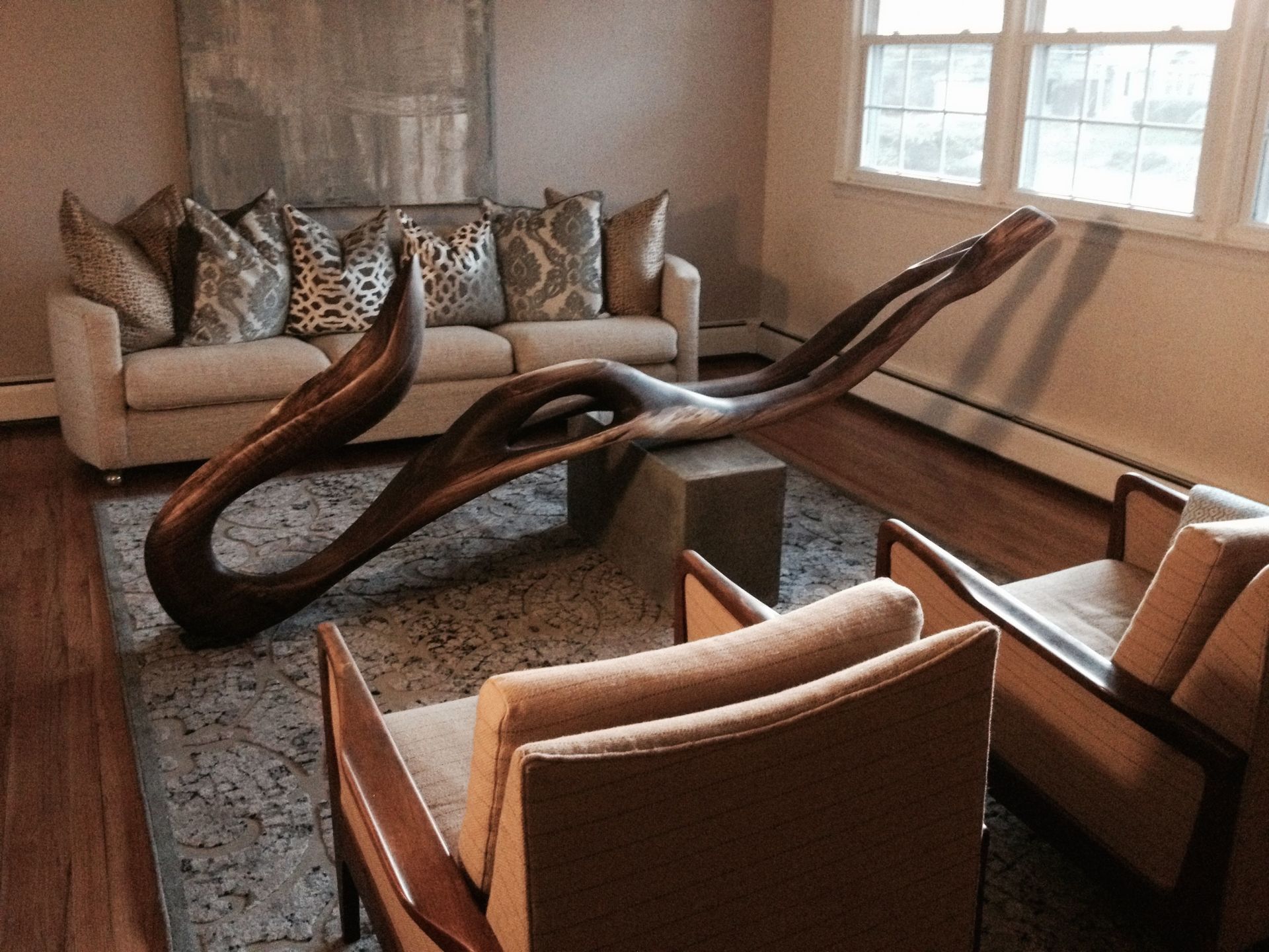 A living room with a couch and two chairs