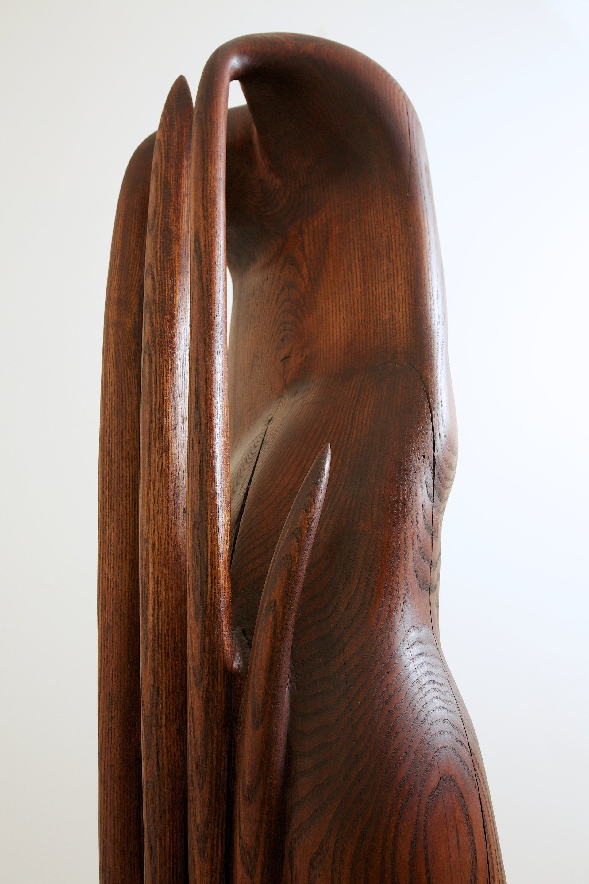 A close up of a wooden sculpture with a white background
