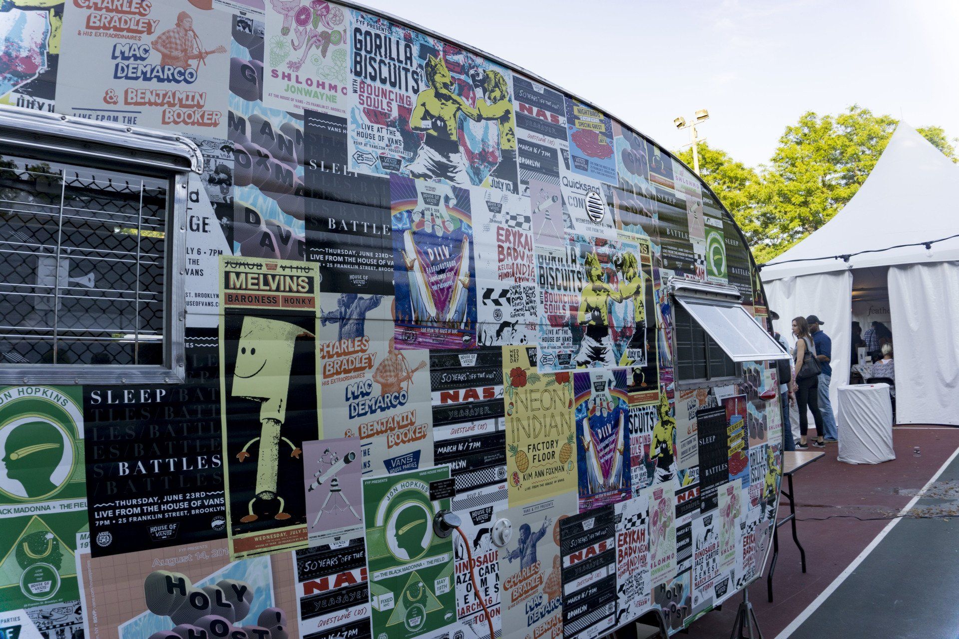 A food truck with a lot of stickers on it