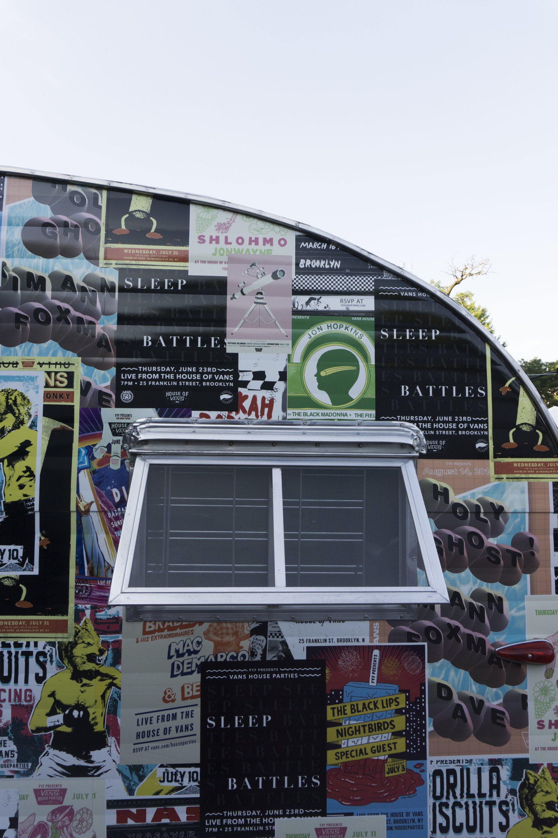 A building with a lot of posters on it and a window.