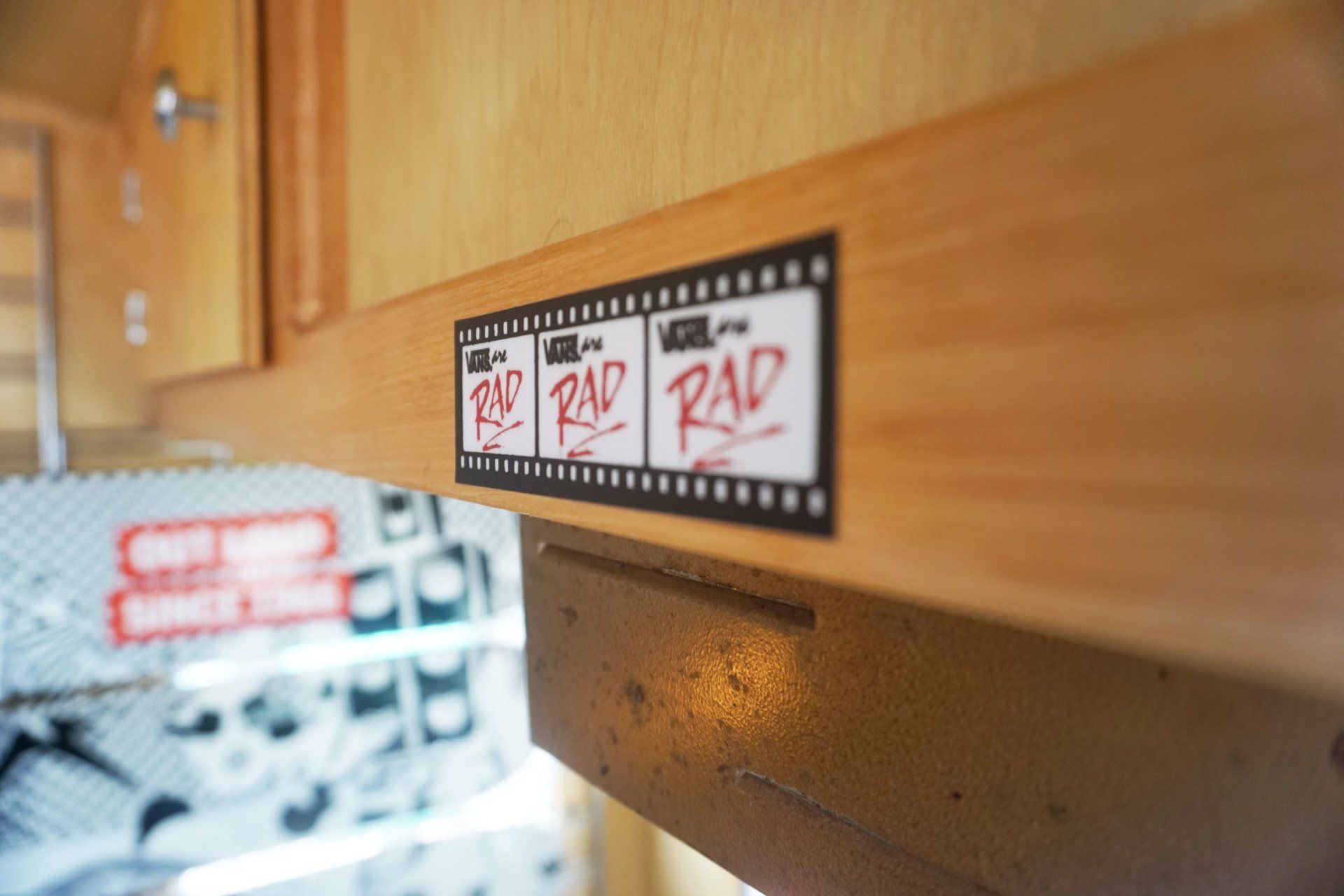 A wooden cabinet with a sticker on it that says rad