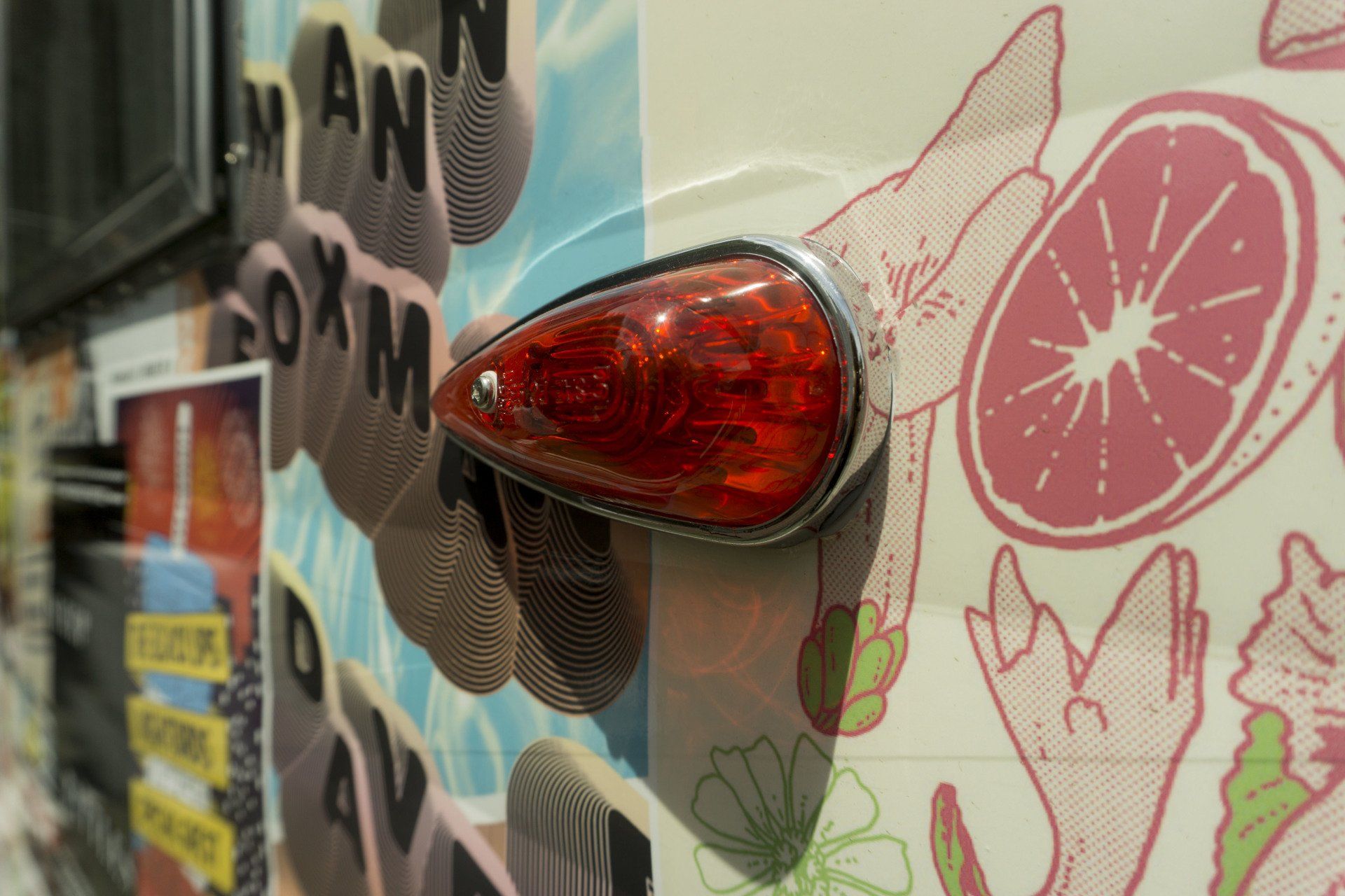 A close up of a red light on the side of a van