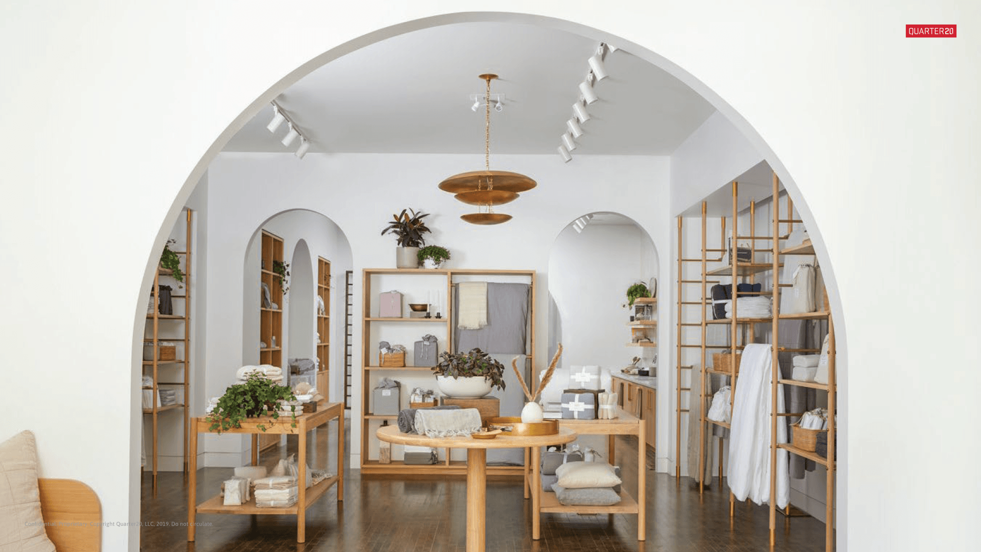 A living room with a couch , table , and shelves.