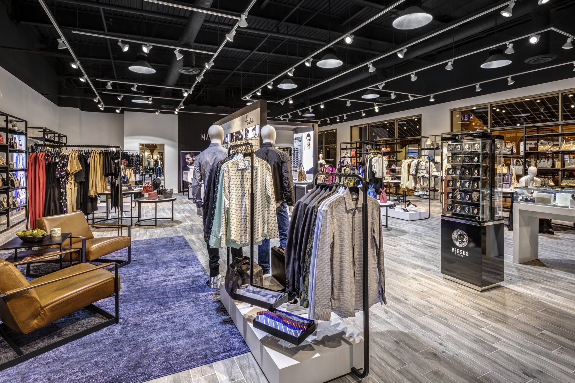 A large clothing store with a lot of clothes on display.