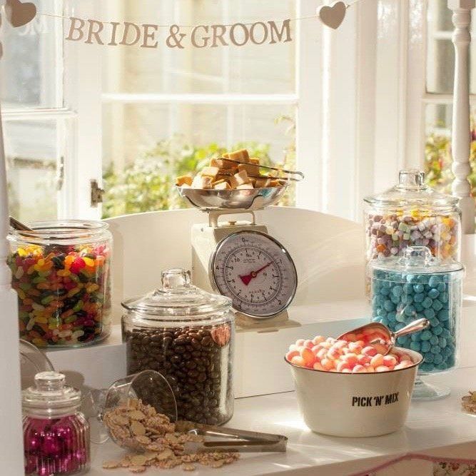 A bride and groom sign hangs above a display of candy