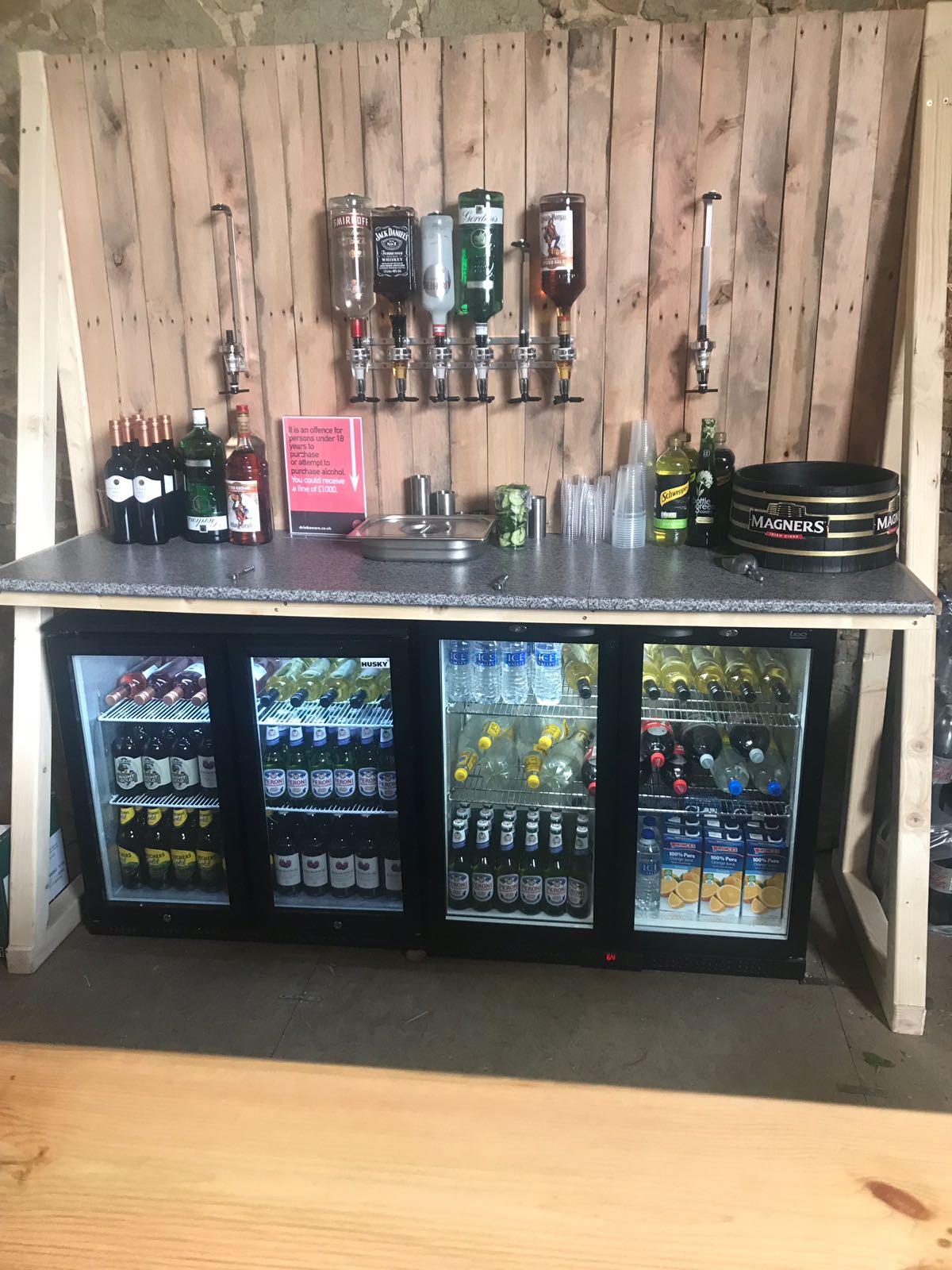 A bar with a lot of drinks and bottles on it
