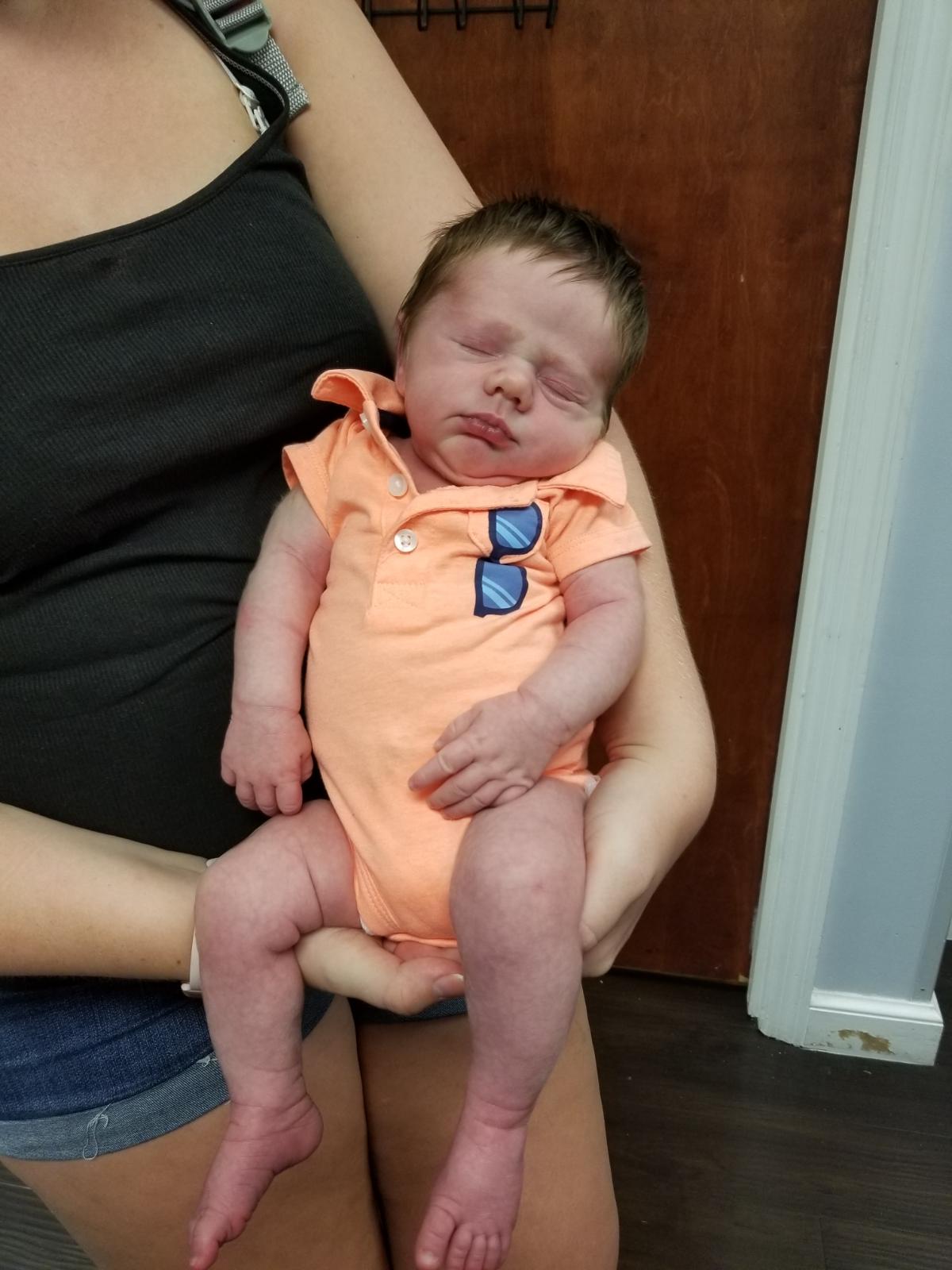 Baby Wearing Orange Romper — Ocala, FL — All About Women OB/GYN Clinic