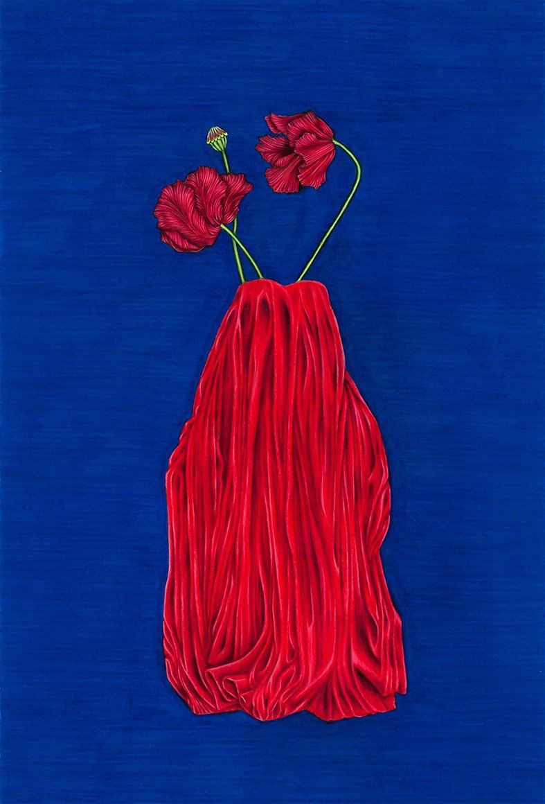 Red fabric vase with three red flowers on blue background.