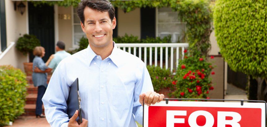 guy in front of rent sign