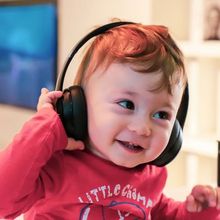 Child listening to music and smiling