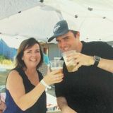 Mary from Gary's Plumbing & Heating and Matt from Advancify are toasting with cups of beer.