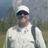 Photo of John Blum smiling outdoors