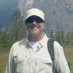 Photo of John Blum smiling outdoors