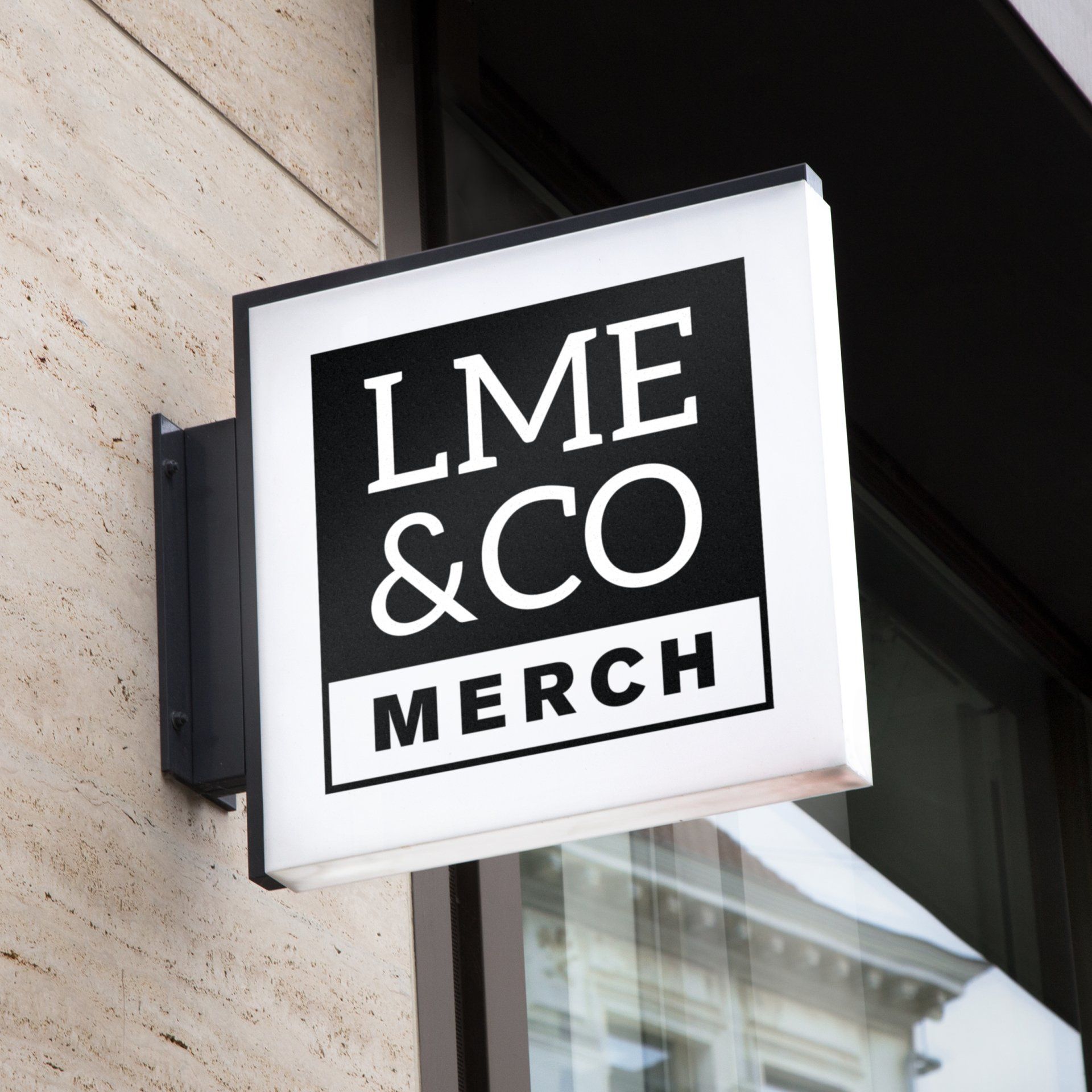 Black-and-white LME & CO MERCH storefront sign on a building exterior