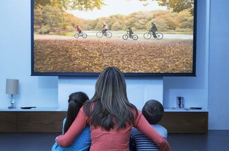 mother and children watching TV