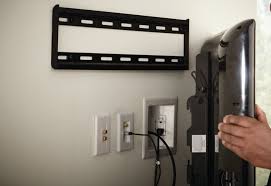 TV being mounted on the wall