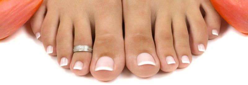 A close up of a woman 's feet with a ring on her finger