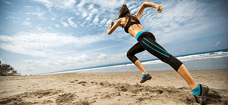 A woman is running on the beach.