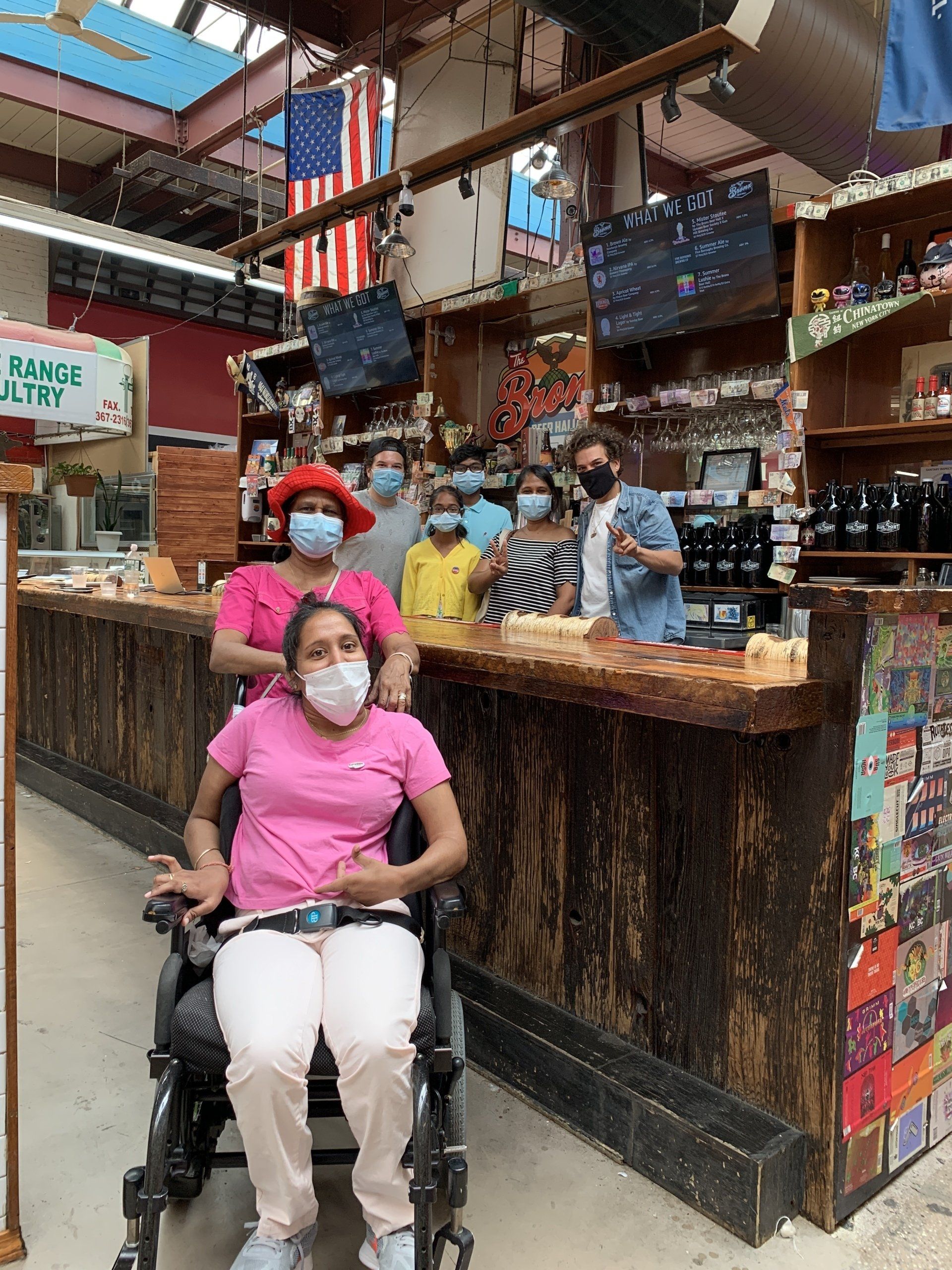 Family all masked is inside of Arthur Avenue Retail Market by Bronx Beer Hall. Lots of funky, colorful design around.