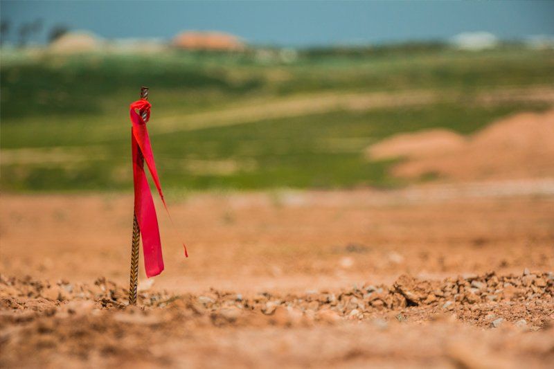 A Land with Red Ribbon Marker — Phoenix, AZ — Blue Horizon Excavating & Grading