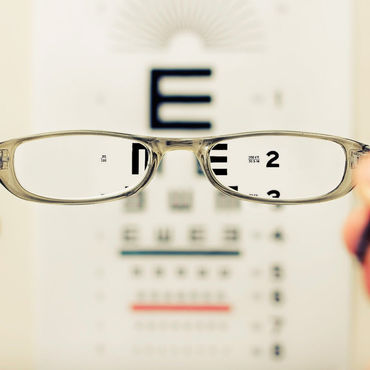 Young woman in the examining her eyesight Young woman in the examining her eyesight
