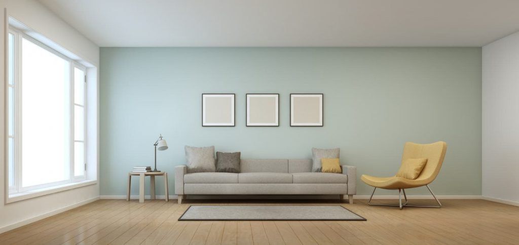minimal living room with grey couch and yellow chair