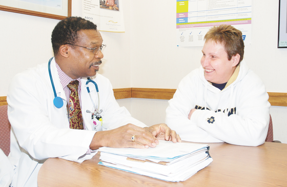 Dr. Richardo Carter meeting with patient Dr. Richardo Carter meeting with patient