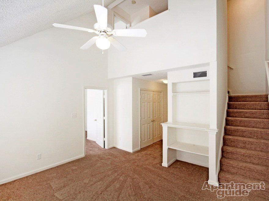 Living Room and View of Staircase at Suites at Port Warwick