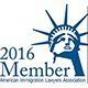 2016 Member logo with blue Statue of Liberty crown and an arched line above the text