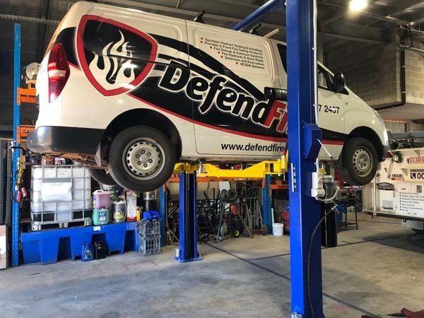 defend fire van on lift in shop