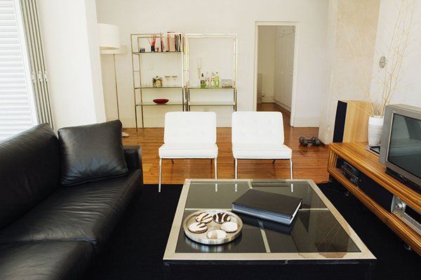 black sofa and white chairs for living room