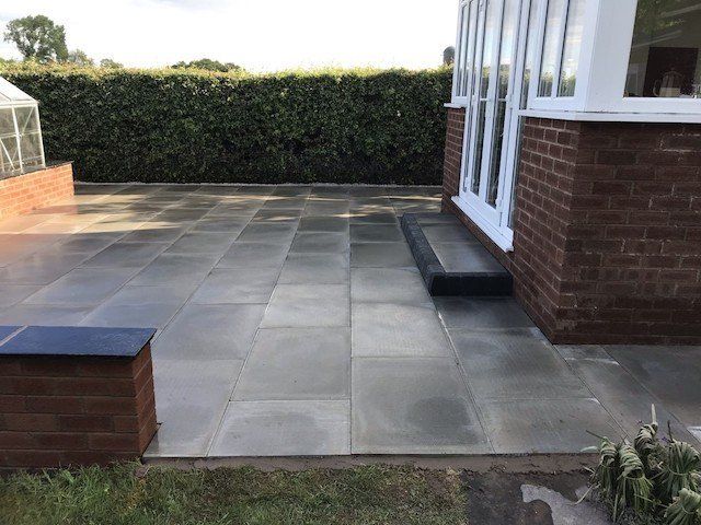 New flagstone patio and garden wall in Dunham-on-the-Hill near Helsby by Cheshire Paving Company