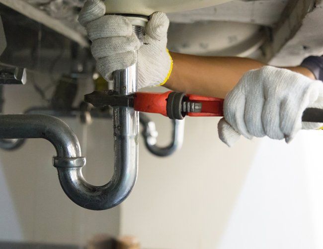 Plumber Fixing the Sink Pipe — Black Creek GA — Tony Perks Plumbing, Inc.