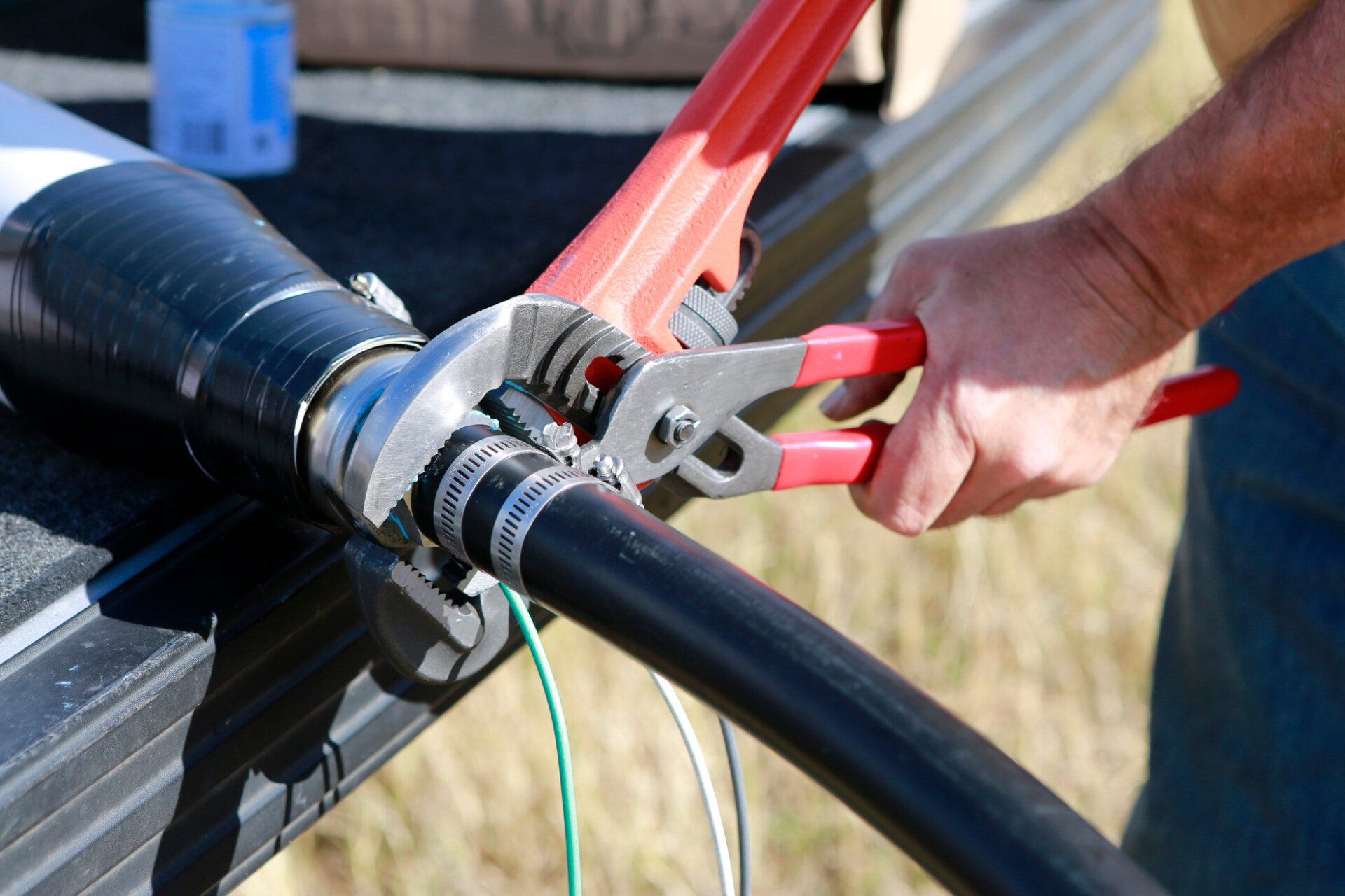 Person Attaching Hose To Pump — Chattanooga, TN — Coddington Enterprise Person Attaching Hose To Pump — Chattanooga, TN — Coddington Enterprise