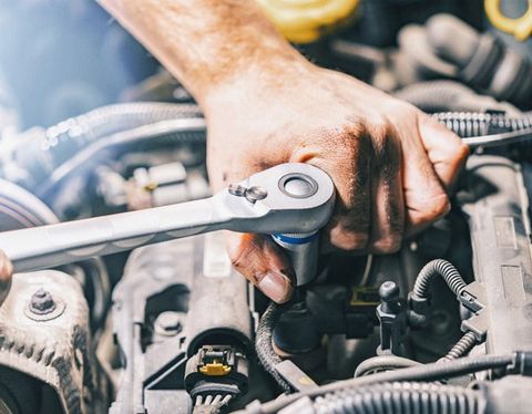 Car Mechanic with Wrench — Colorado Springs, CO — A Action Services, LLC. Car Mechanic with Wrench — Colorado Springs, CO — A Action Services, LLC.