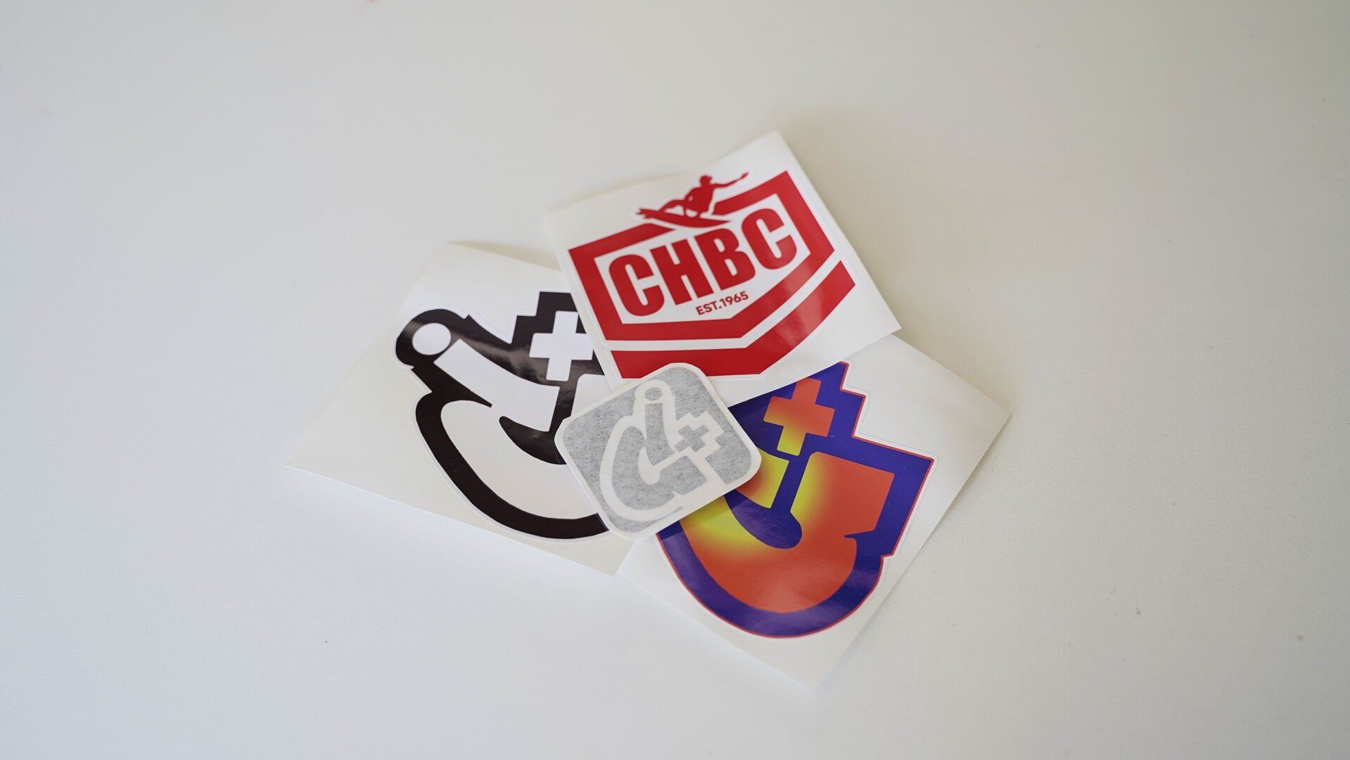 A bunch of stickers with one that says chbc on it