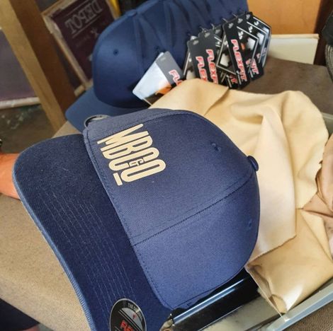 Blue Cap With White Print And Set Of Blue Caps In Background — Printing in Coffs Harbour, NSW