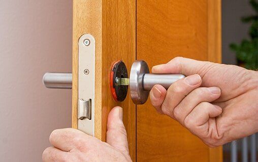 Handyman repairing a door handle - Door Locks in Brainerd, MN Handyman repairing a door handle - Door Locks in Brainerd, MN