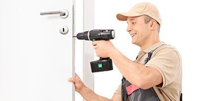 Locksmith screwing a screw on lock of a door - Residential Lock Service in Brainerd, MN Locksmith screwing a screw on lock of a door - Residential Lock Service in Brainerd, MN