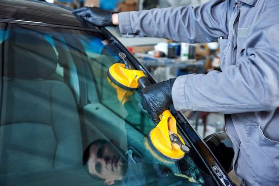 Man replacing a car windscreen man replacing a car windscreen