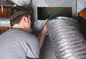 Image of a person cleaning air ducts Image of a person cleaning air ducts