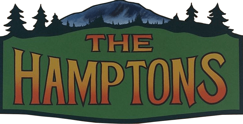 A green sign that says the hamptons on it
