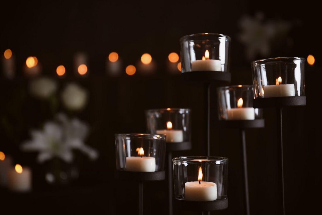 candele accese in camera ardente