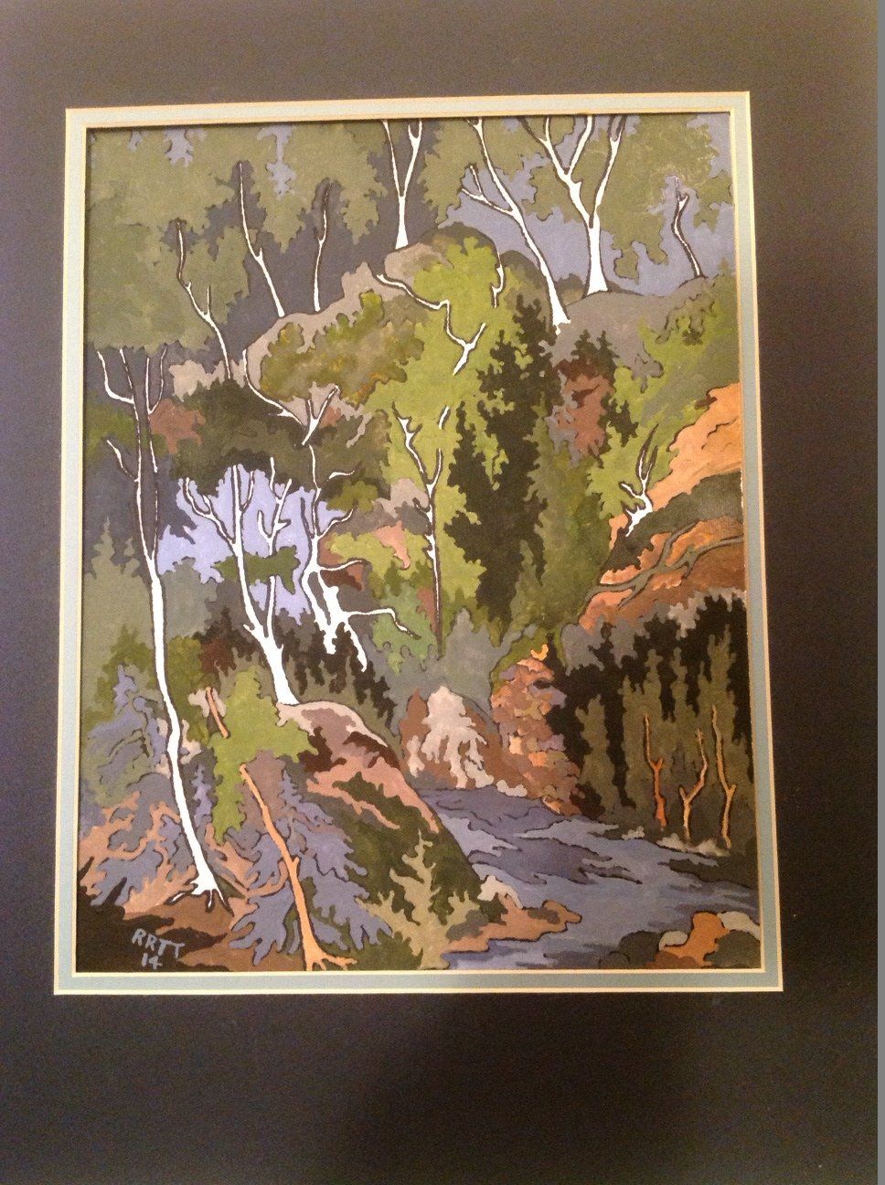 A framed painting of a forest with trees and rocks