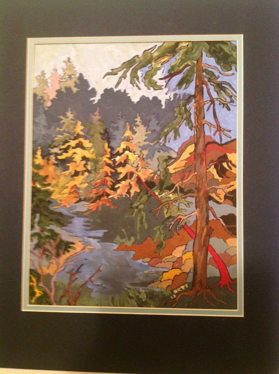 A framed painting of a river surrounded by trees