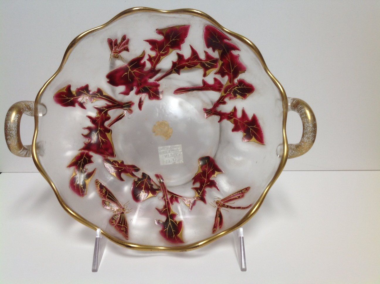 A white plate with red leaves on it