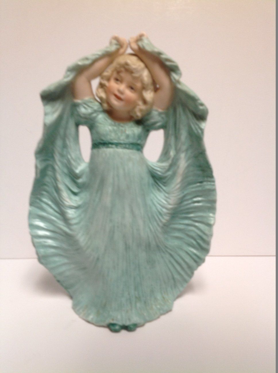 A figurine of a girl in a blue dress