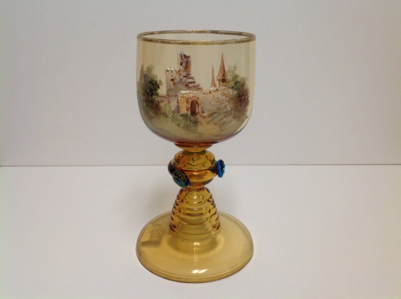 A wine glass with a picture of a castle on it