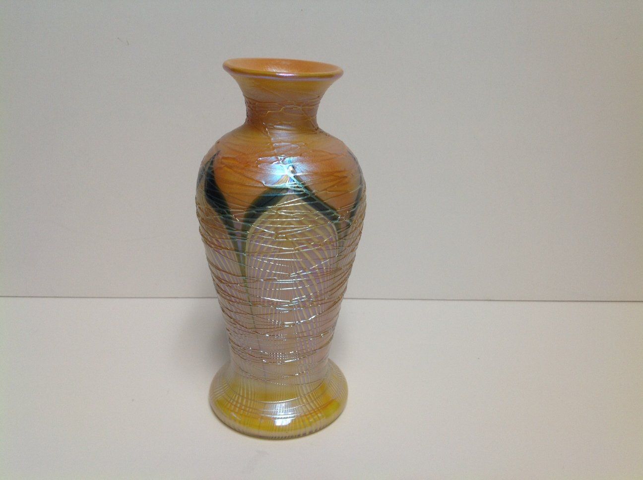 A brown vase is sitting on a white table.
